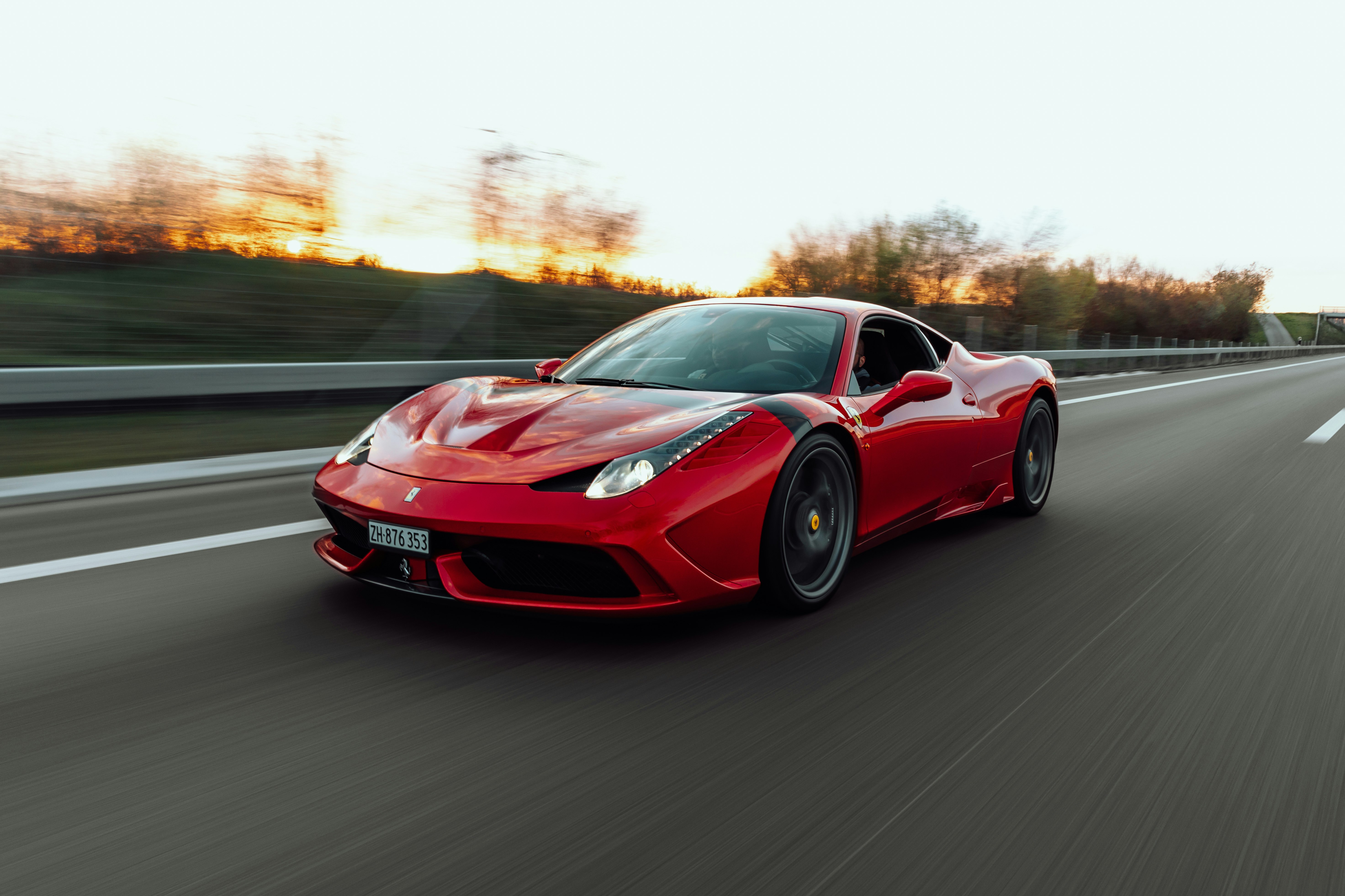 red ferrari 458 italia on road during daytime